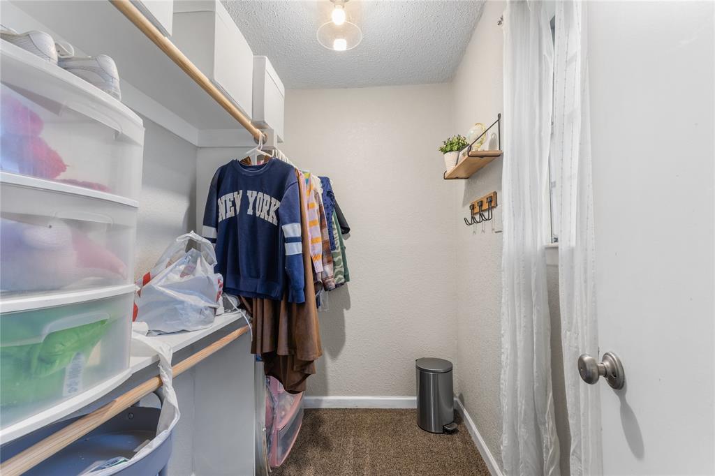 613 Edwards Drive Denison, TX 75020 - Photo 23 of 31 a view of walk in closet with clothes and shoes