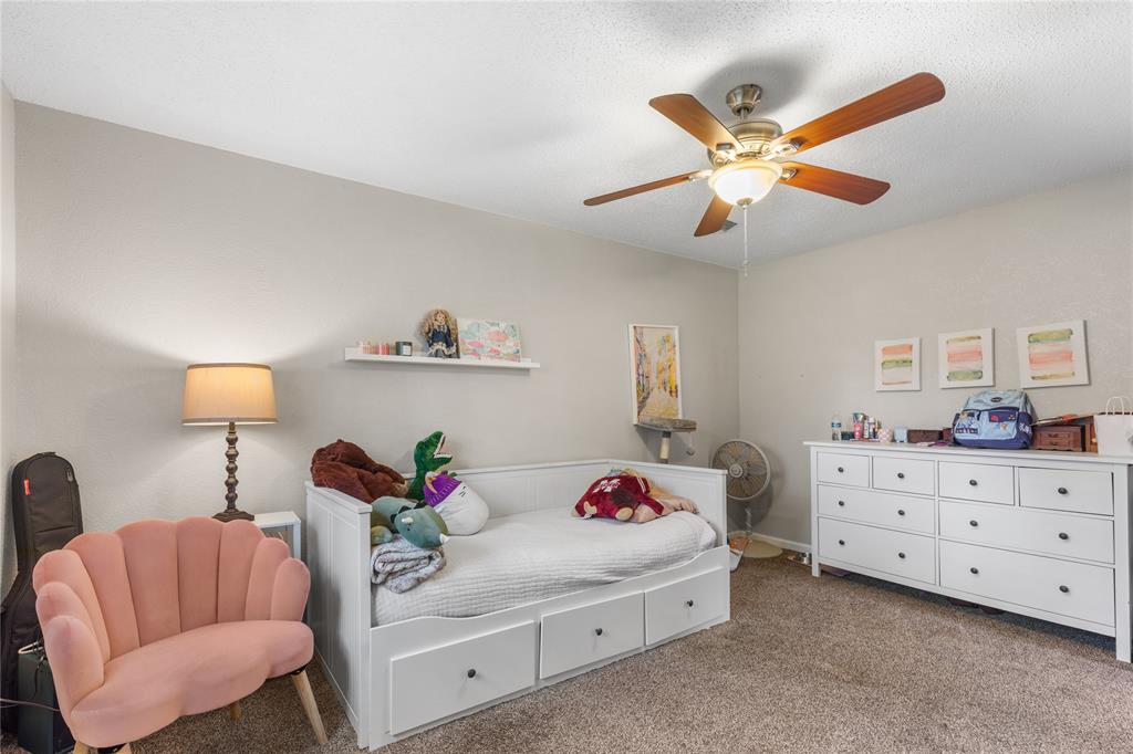 613 Edwards Drive Denison, TX 75020 - Photo 24 of 31 a bedroom with a bed and a chandelier