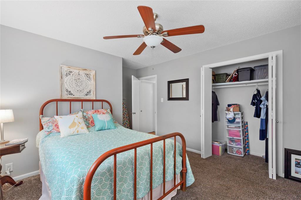 613 Edwards Drive Denison, TX 75020 - Photo 28 of 31 a bedroom with a large bed and a ceiling fan