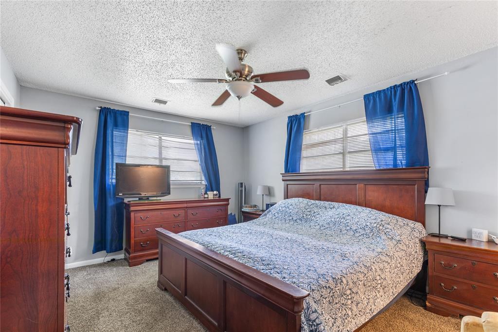 613 Edwards Drive Denison, TX 75020 - Photo 29 of 31 a bedroom with a bed and a flat screen tv