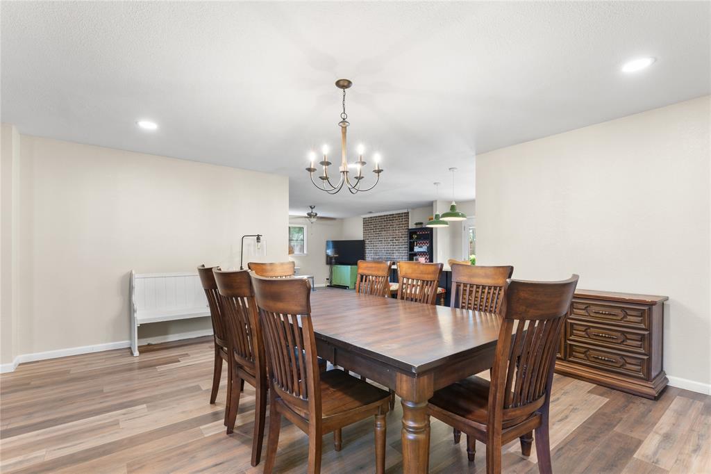 613 Edwards Drive Denison, TX 75020 - Photo 30 of 31 a view of a dining room with furniture wooden floor and chandelier