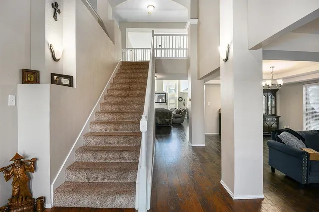 a view of entryway and hall with wooden floor