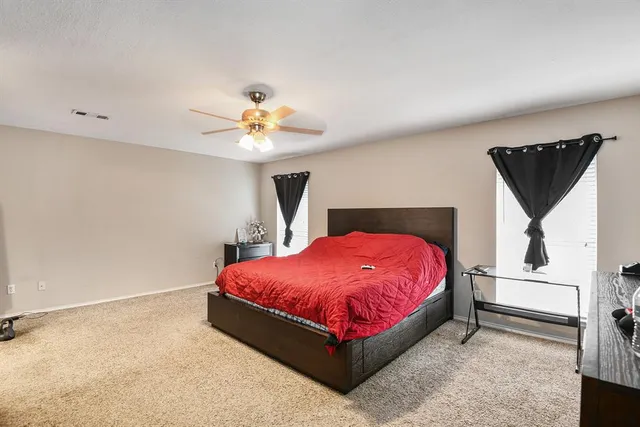 a bed room with a bed and a chandelier