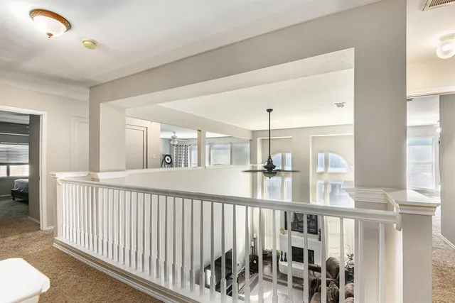 a view of staircase with two windows