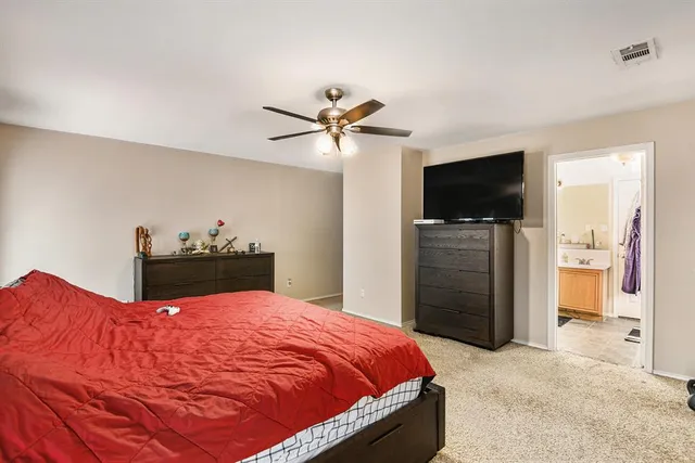 a bed room with a bed and a flat screen tv