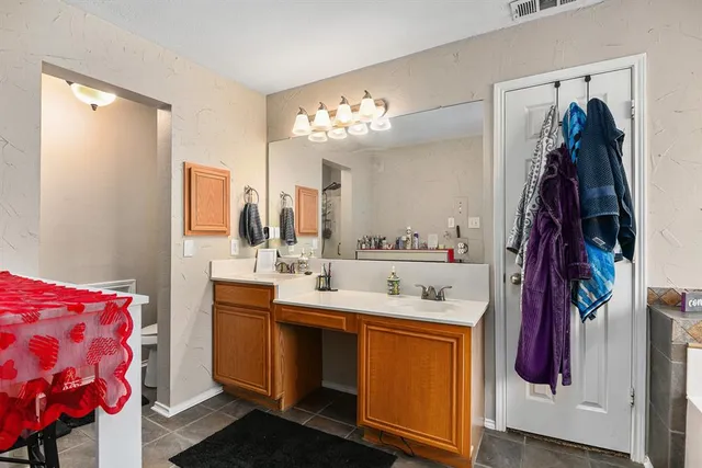 a bathroom with a sink vanity and a mirror