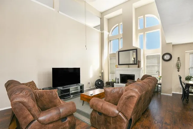 a living room with fireplace furniture and a flat screen tv