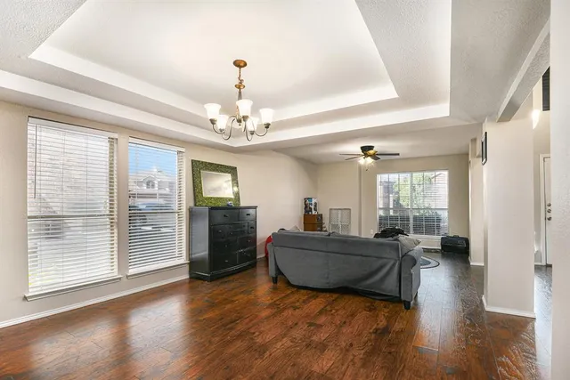 a living room with furniture and a chandelier