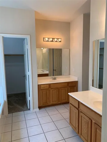 a bathroom with a sink a vanity and a mirror