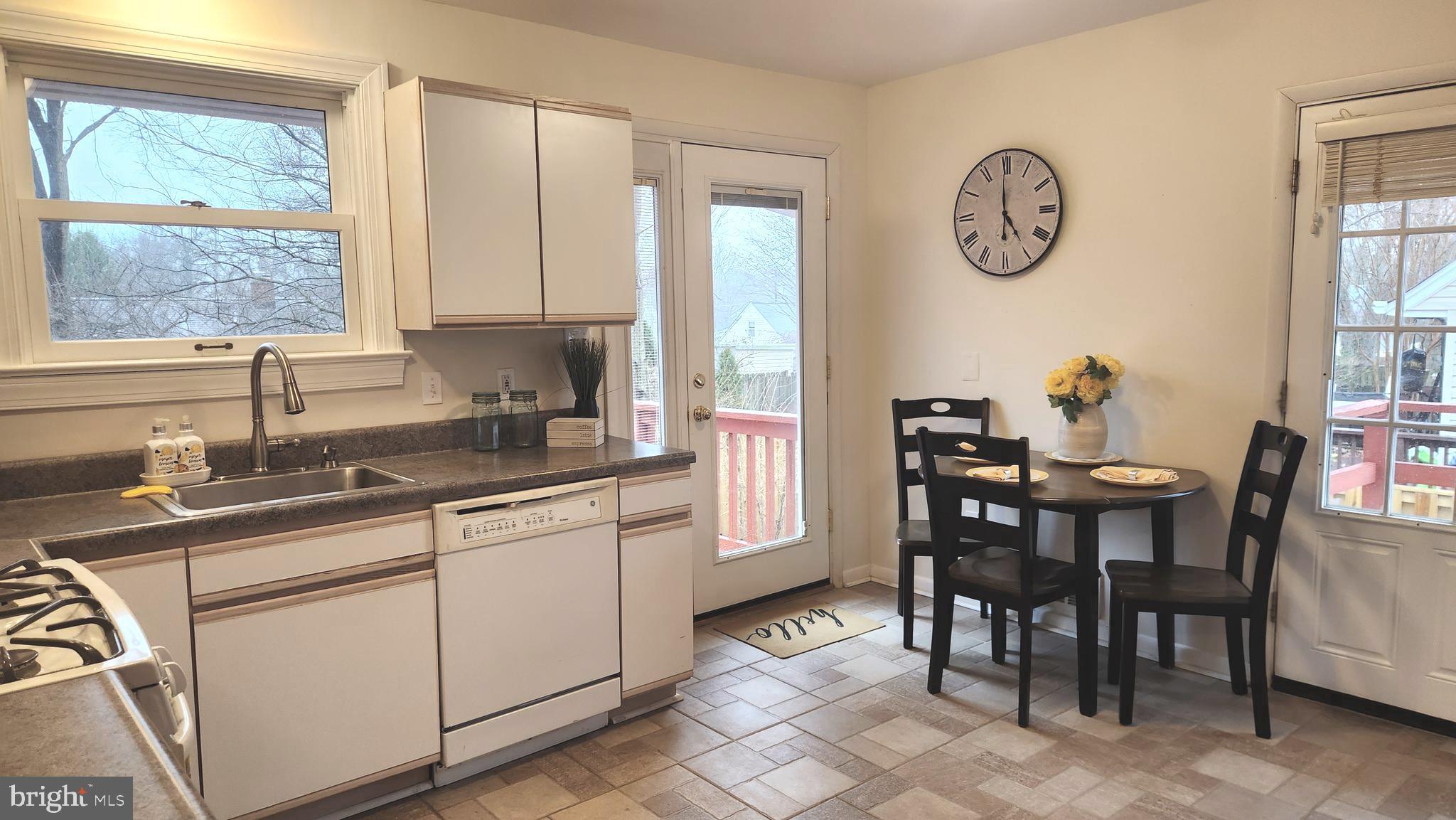 1002 Laredo Road Silver Spring, MD 20901 - Photo 60 of 70 a kitchen with a table chairs sink and cabinets
