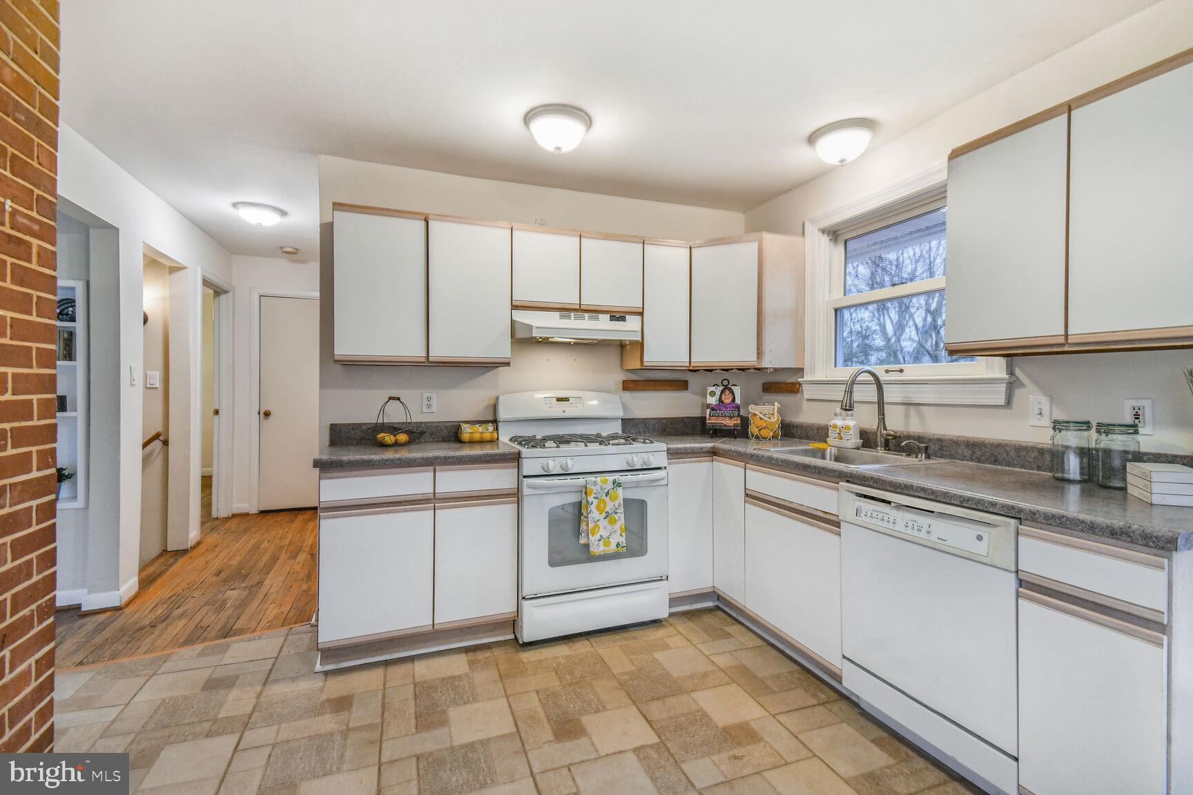 1002 Laredo Road Silver Spring, MD 20901 - Photo 6 of 70 a kitchen with a sink window and cabinets