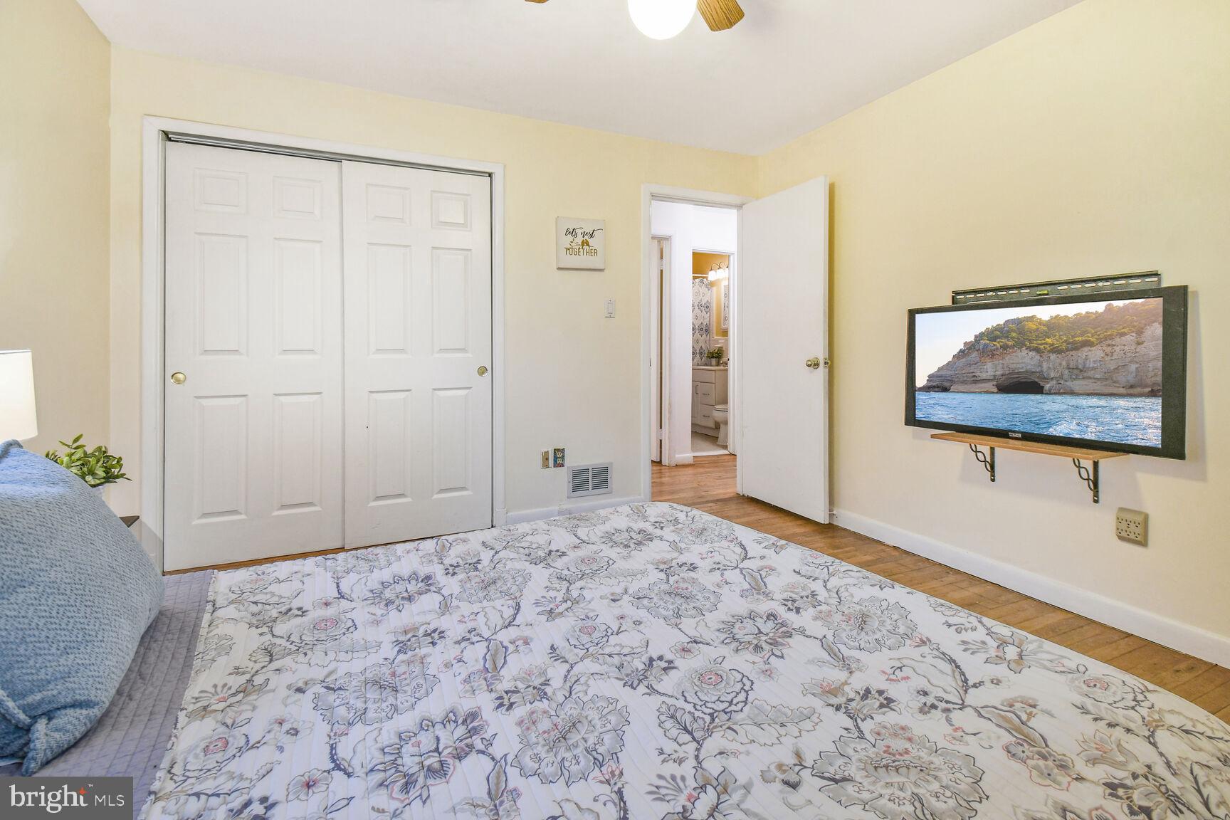1002 Laredo Road Silver Spring, MD 20901 - Photo 8 of 70 a bedroom with a bed and a flat screen tv