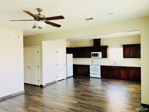 a living room with fireplace furniture and a wooden floor