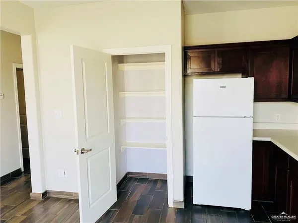 a view of walk in closet with wooden floor and cabinet