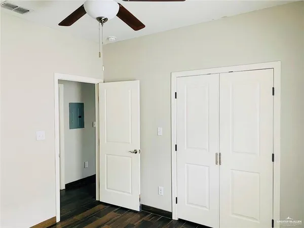 a view of a hallway with wooden floor
