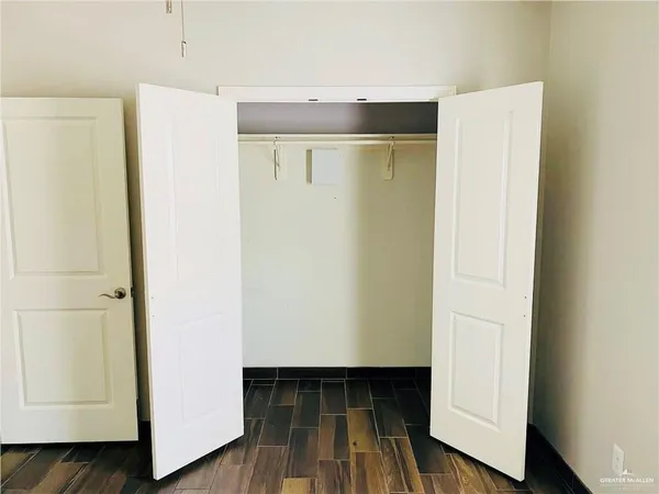 a view of walk in closet with wooden floor