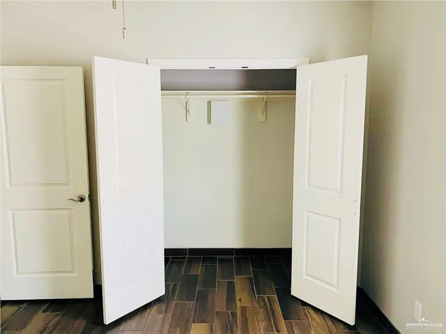 a view of walk in closet with wooden floor