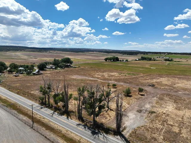 a view of a swimming pool with a yard and sitting area