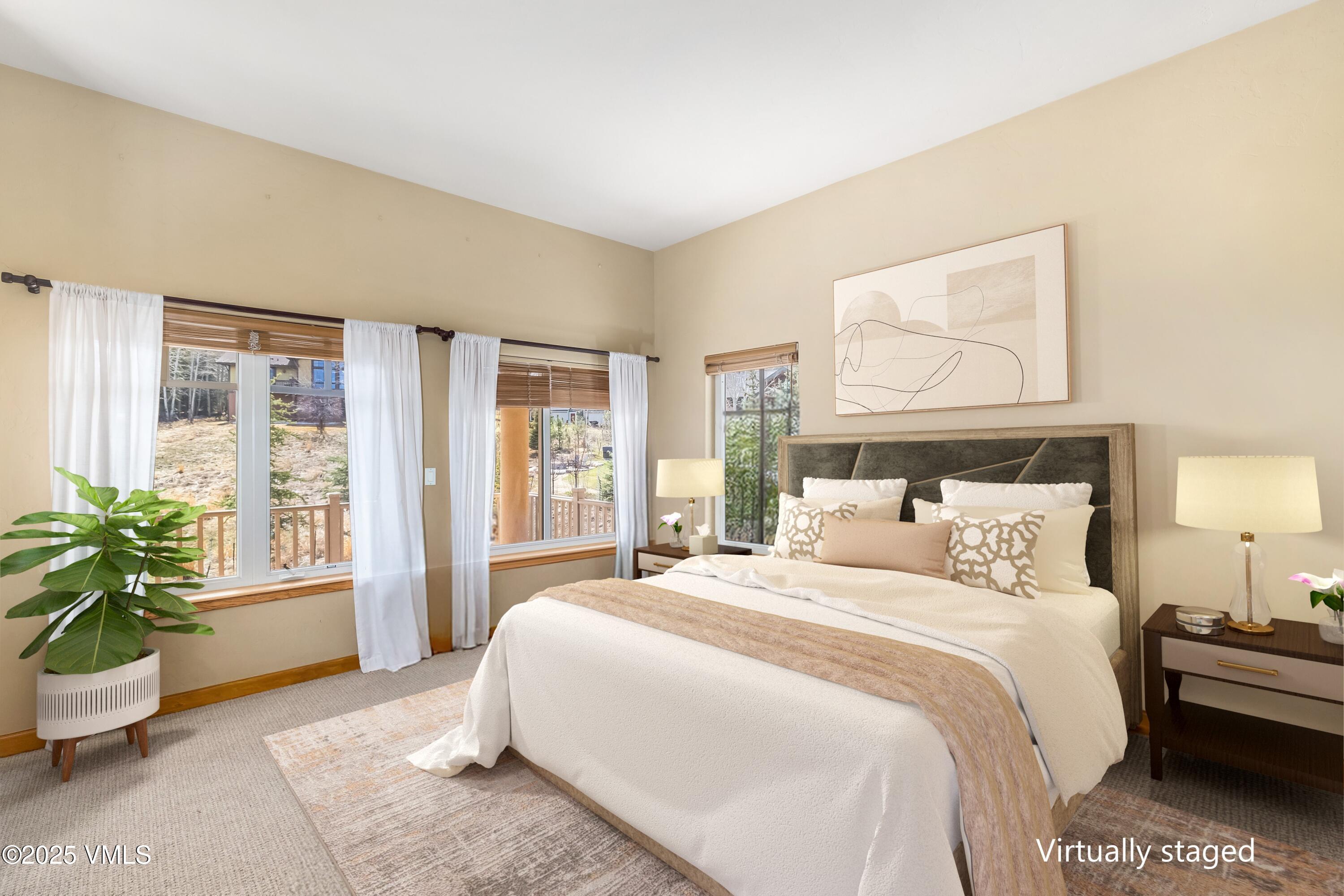 111 East Double Hitch Eagle, CO 81631 - Photo 12 of 38 a bedroom with a large bed and a potted plant