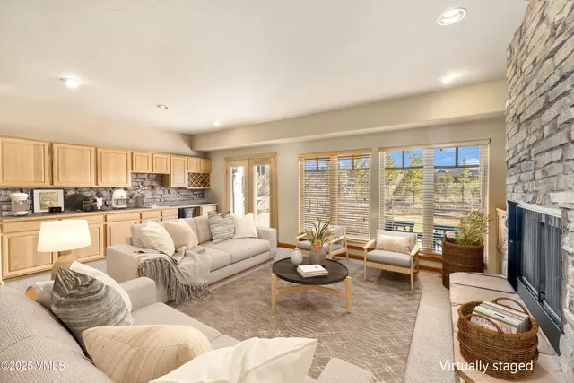a living room with furniture large windows and a flat screen tv