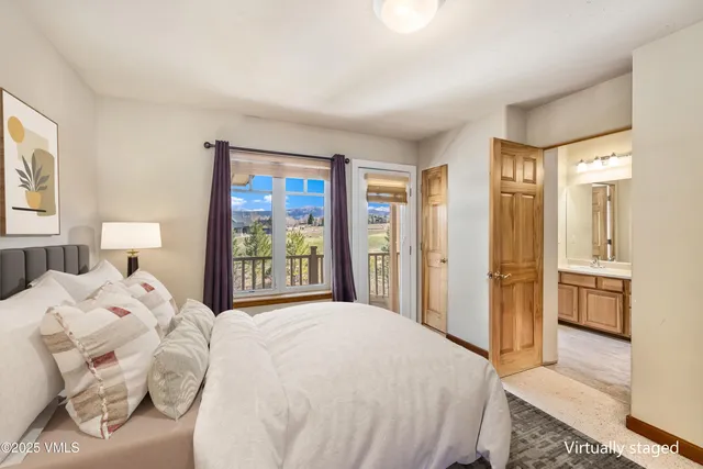 a bedroom with a bed and a large mirror