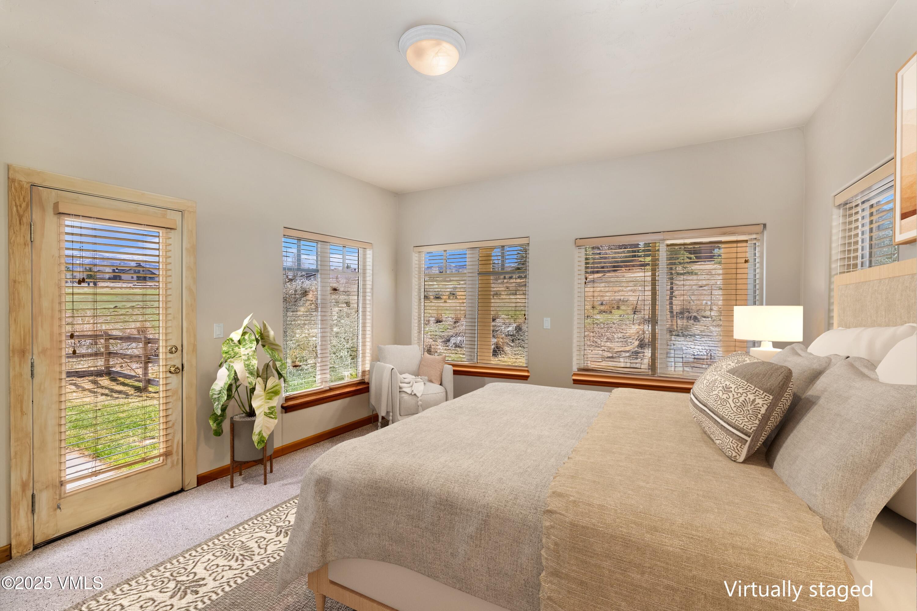 111 East Double Hitch Eagle, CO 81631 - Photo 29 of 38 a spacious bedroom with a bed and glass window