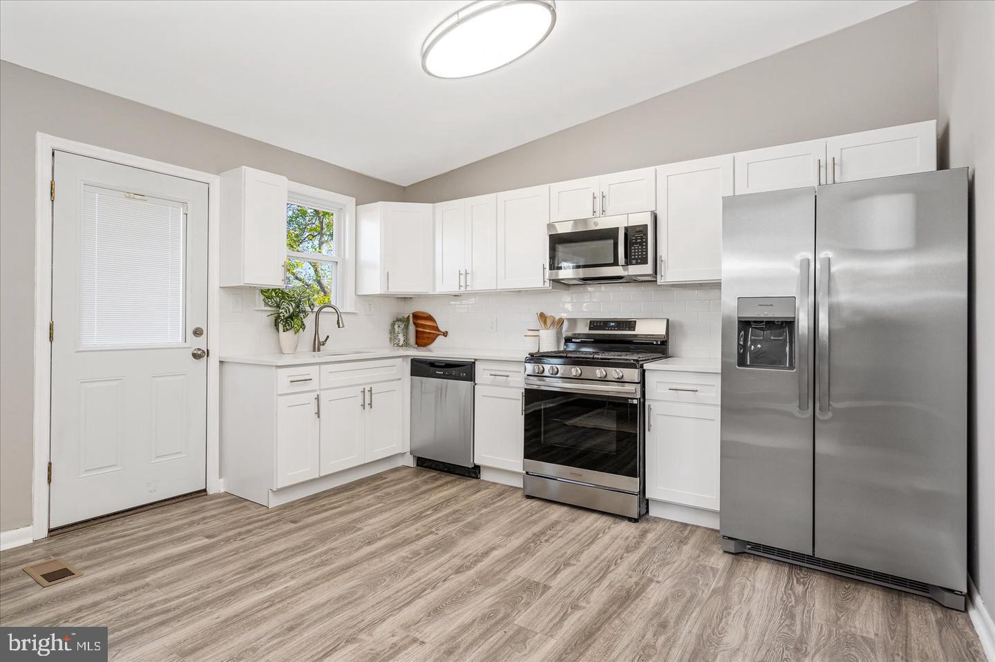 4609 Tema Road Pikesville, MD 21208 - Photo 11 of 36 a kitchen with a refrigerator and a stove top oven