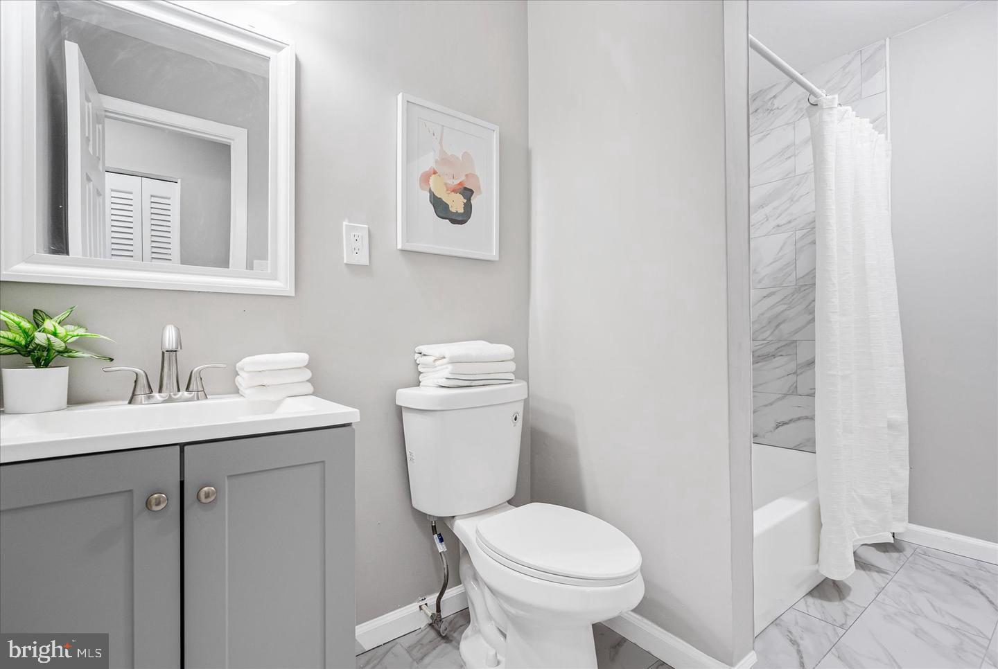 4609 Tema Road Pikesville, MD 21208 - Photo 14 of 36 a bathroom with a toilet sink and mirror