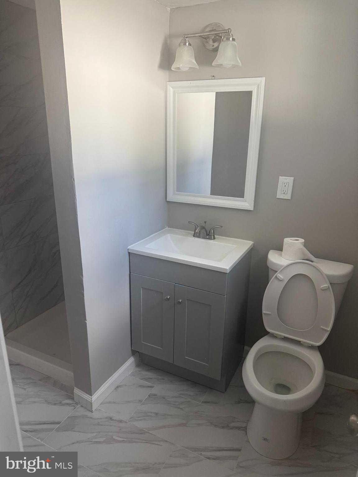 4609 Tema Road Pikesville, MD 21208 - Photo 25 of 36 a bathroom with a toilet sink and mirror