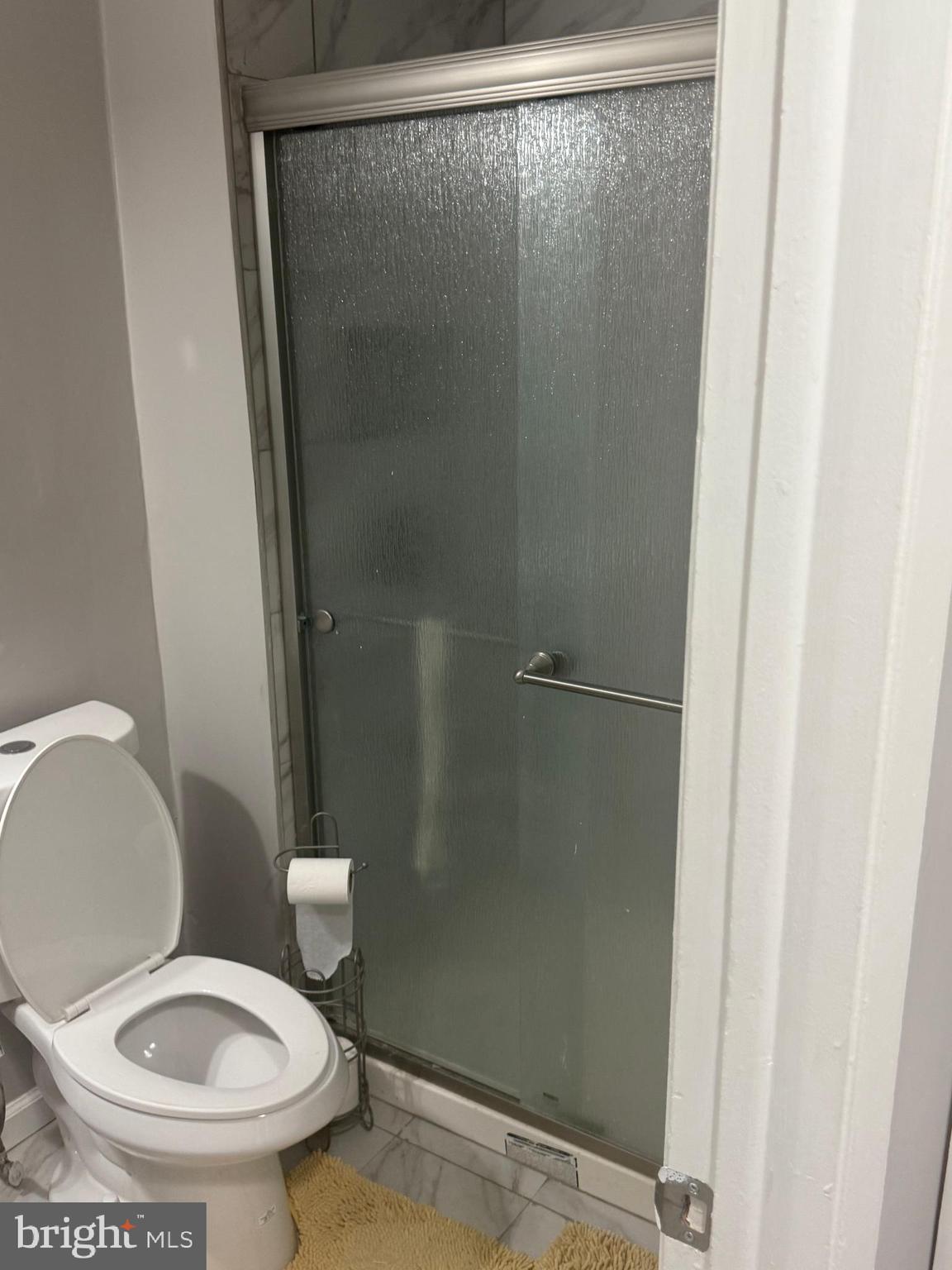 4609 Tema Road Pikesville, MD 21208 - Photo 30 of 36 a white toilet sitting next to a shower