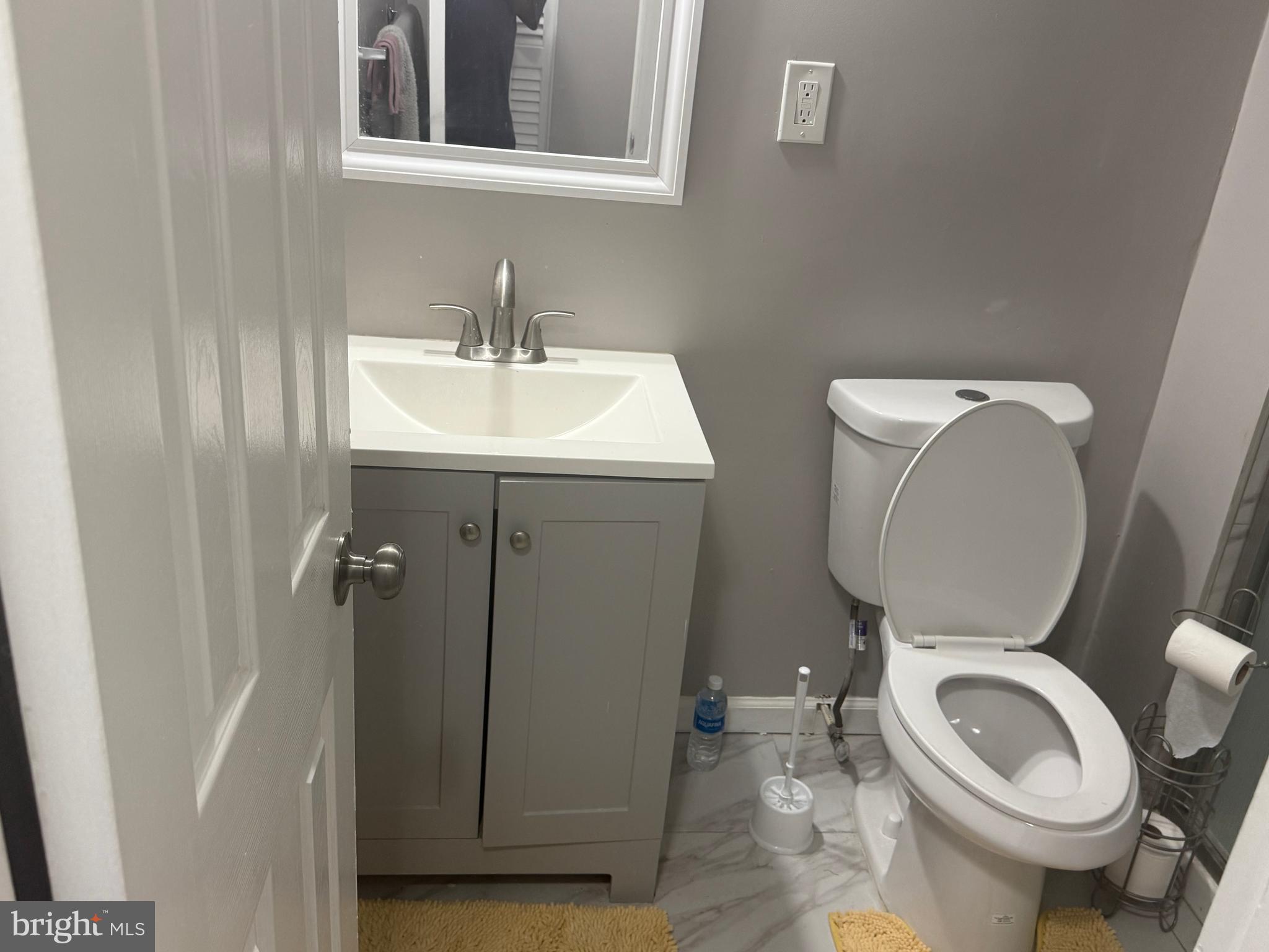 4609 Tema Road Pikesville, MD 21208 - Photo 31 of 36 a bathroom with a toilet sink and mirror