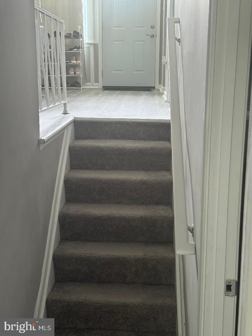 4609 Tema Road Pikesville, MD 21208 - Photo 34 of 36 a view of staircase with white walls and a window