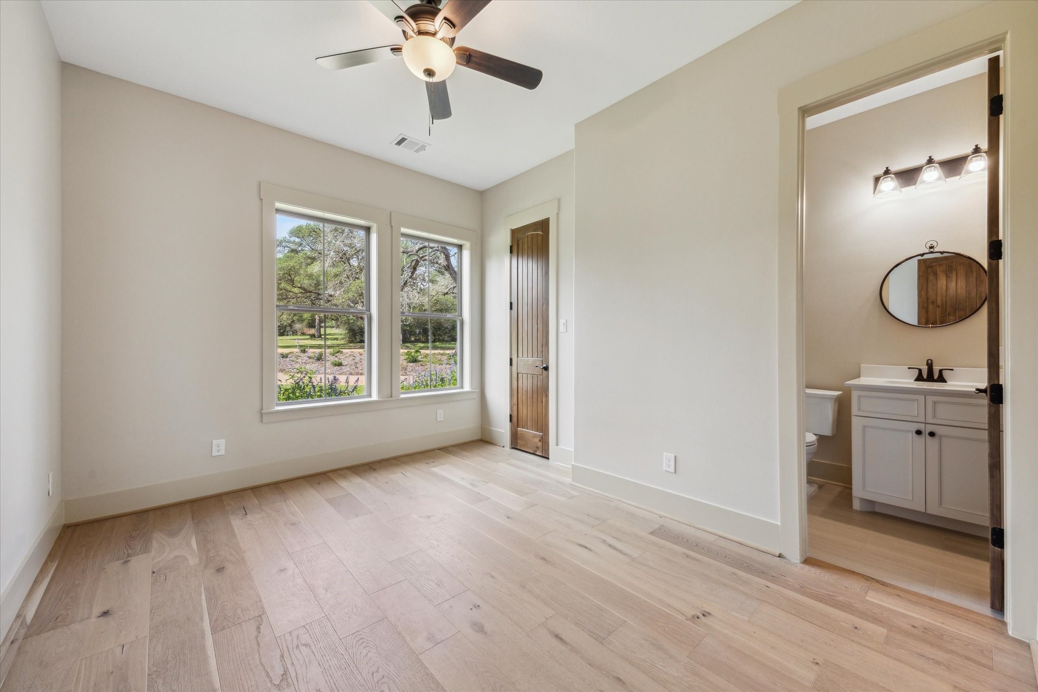 2130 Hartfield Road Round Top, TX 78954 - Photo 18 of 35 a view of a room with a sink wooden floor and windows