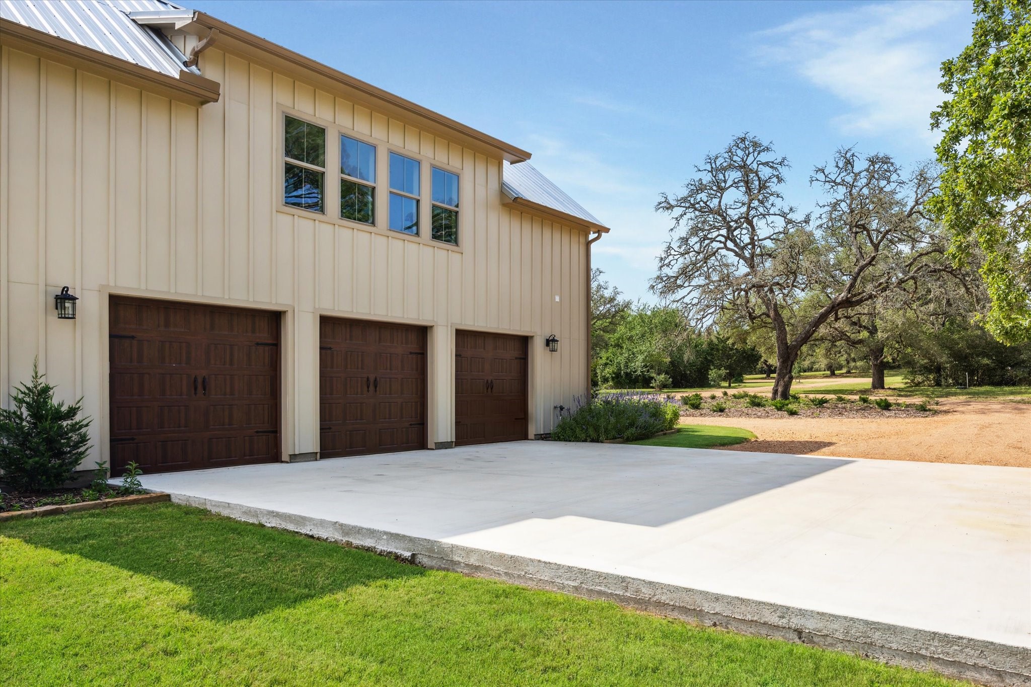 2130 Hartfield Road Round Top, TX 78954 - Photo 31 of 35 a front view of a house with a yard and garage