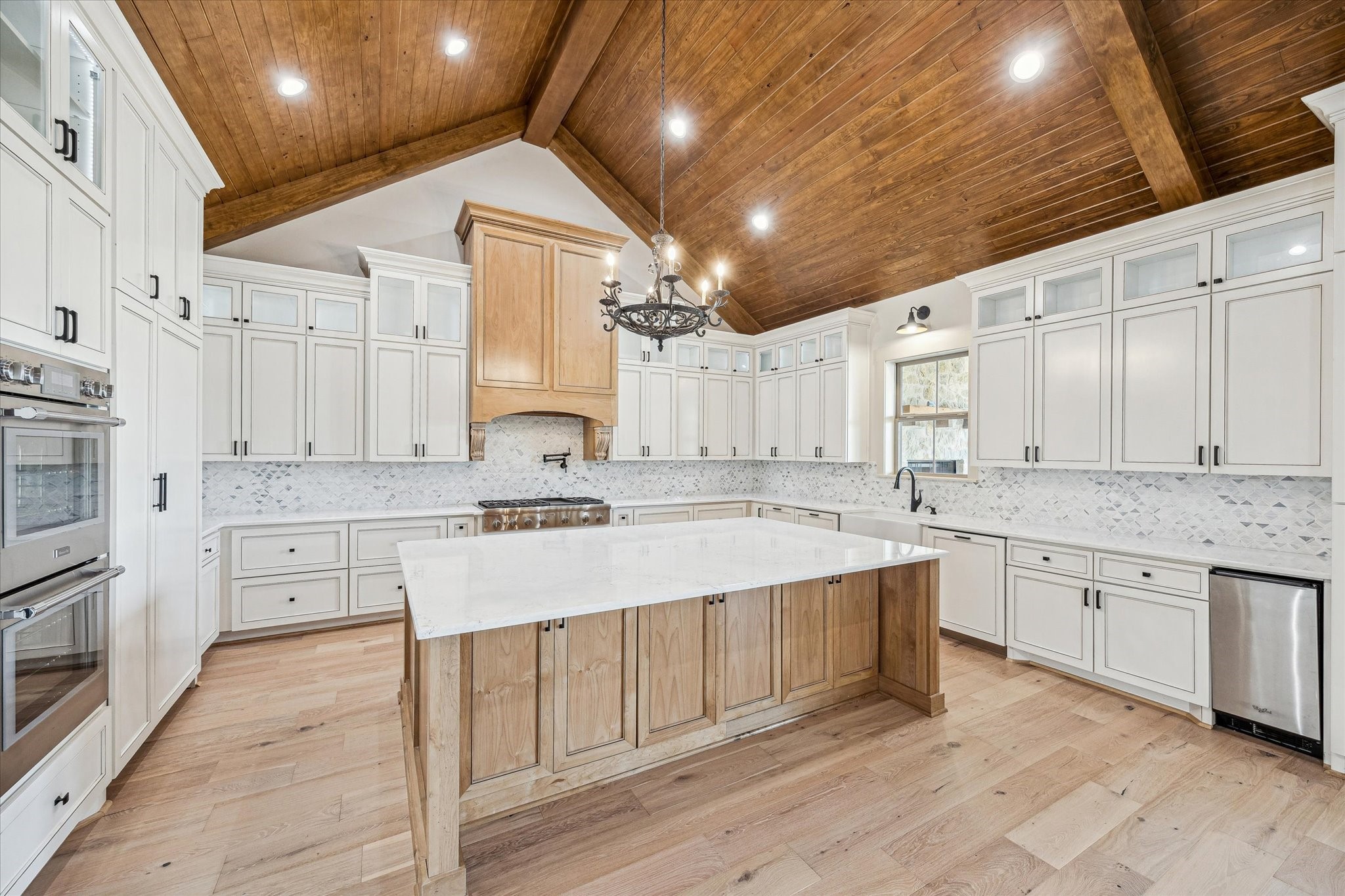 2130 Hartfield Road Round Top, TX 78954 - Photo 35 of 35 a large kitchen with cabinets a sink and white appliances