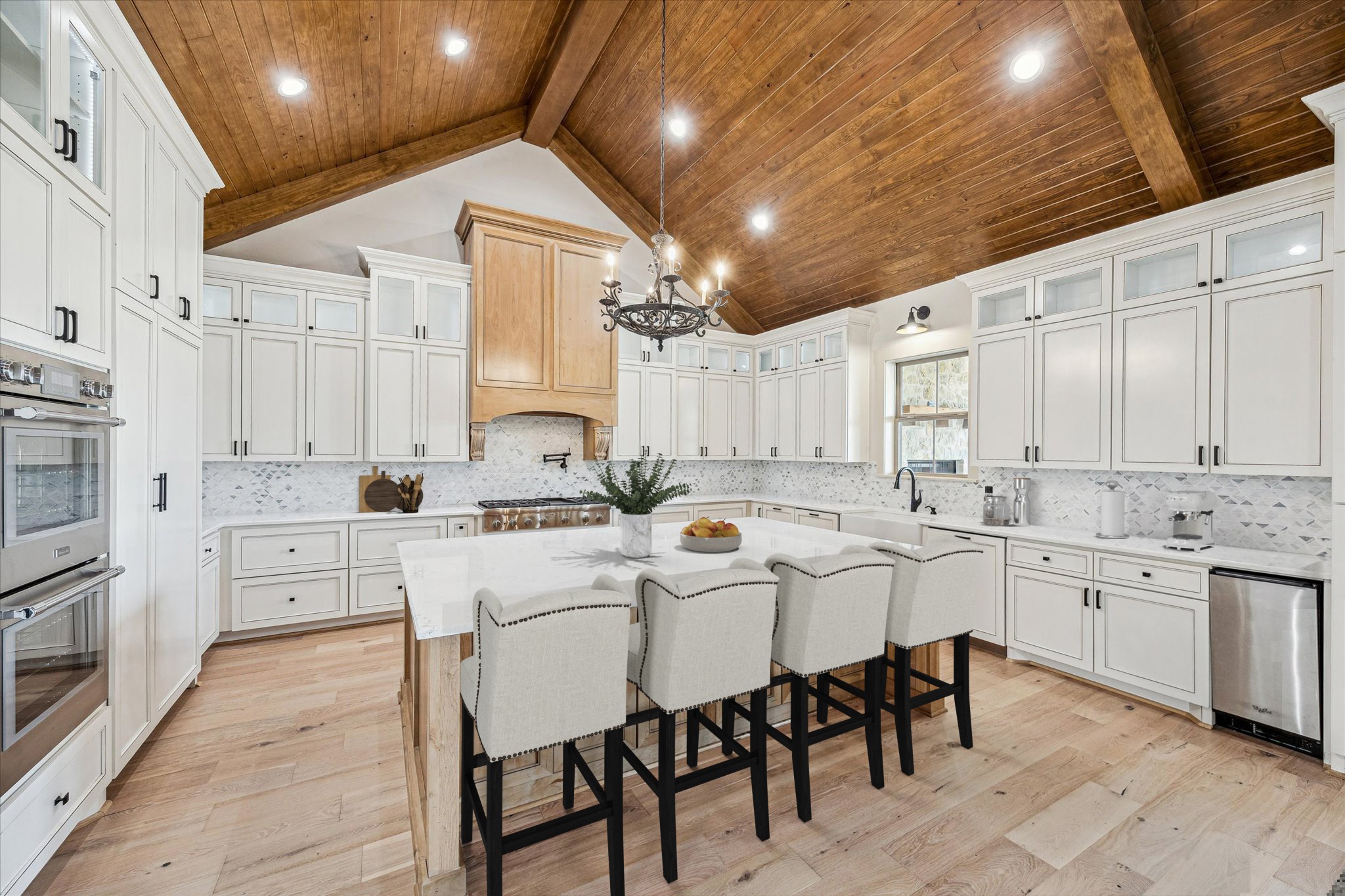 2130 Hartfield Road Round Top, TX 78954 - Photo 5 of 35 a large white kitchen with stainless steel appliances kitchen island granite countertop lots of white cabinets appliances and furniture