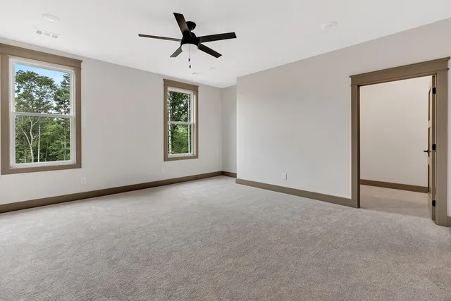 a view of a livingroom with a ceiling fan and window