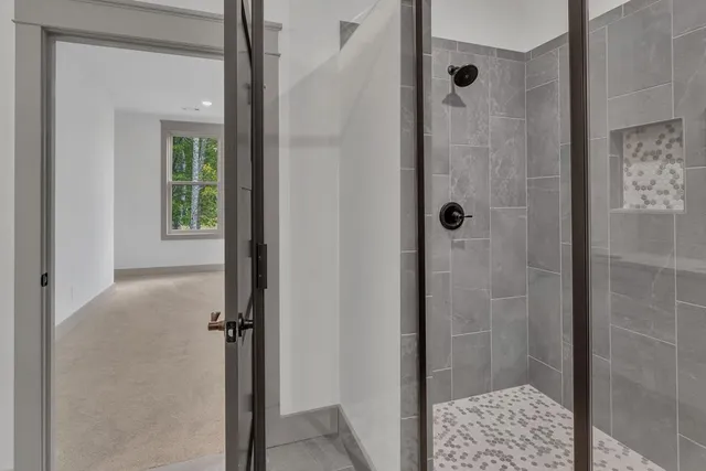 a bathroom with a glass shower door