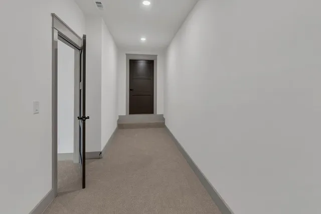 a view of a hallway with wooden shelves