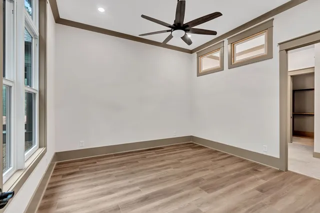 a view of a room with wooden floor and a window