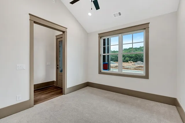 an empty room with windows and closet