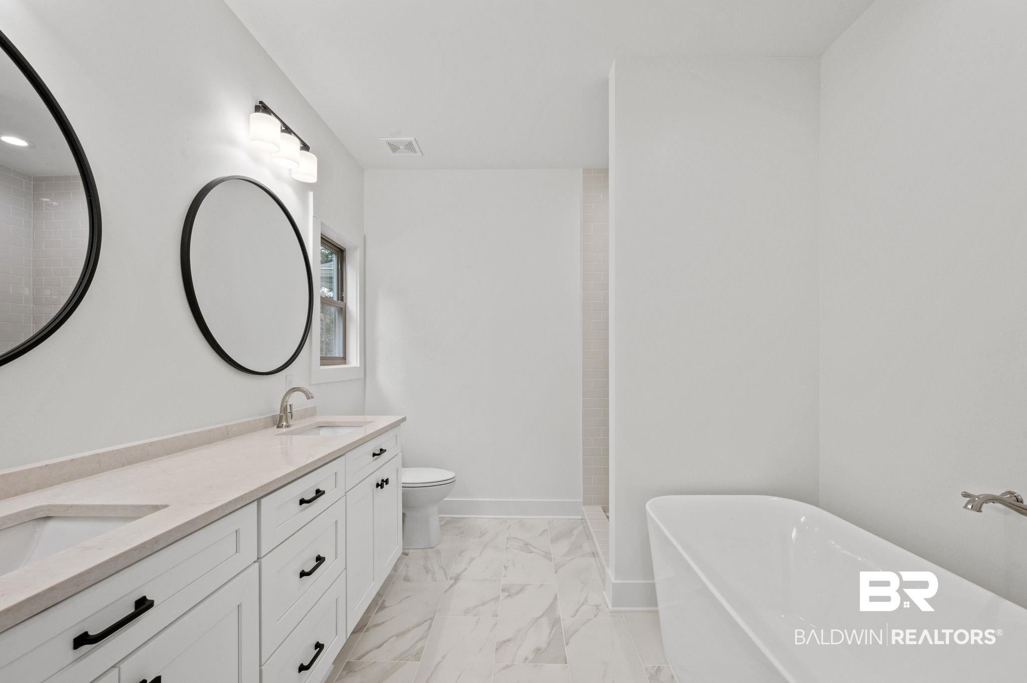 12412 Mannich Lane Foley, AL 36535 - Photo 13 of 23 Bathroom with a bathing tub, toilet, double vanity, and tile patterned flooring