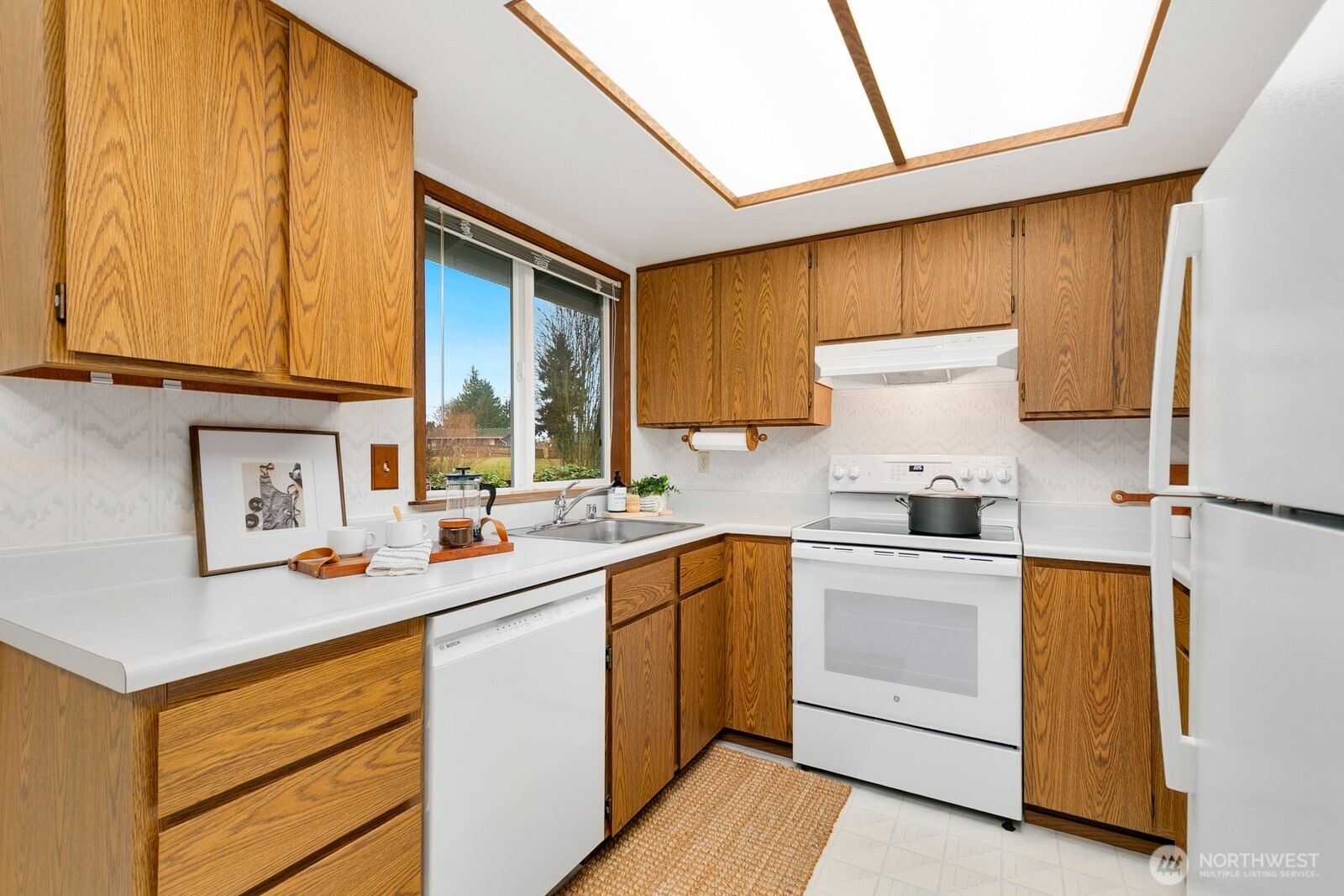 12903 Southeast 160th Street Renton, WA 98058 - Photo 10 of 24 a kitchen with a sink stove and cabinets