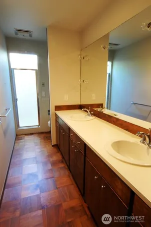 a spacious bathroom with a granite countertop sink and a mirror