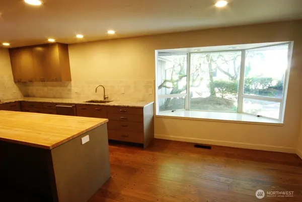 a bathroom with a large tub a sink and a large window