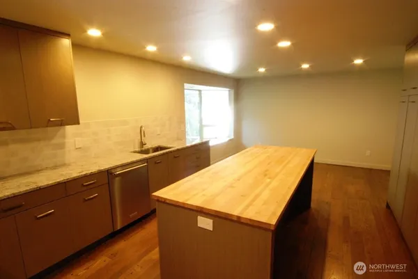a kitchen with a sink and wooden cabinets