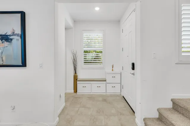 a living room with furniture a window and a table