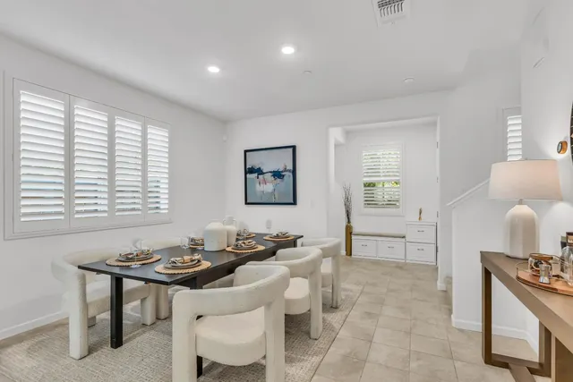 a living room with furniture a window and a dining table
