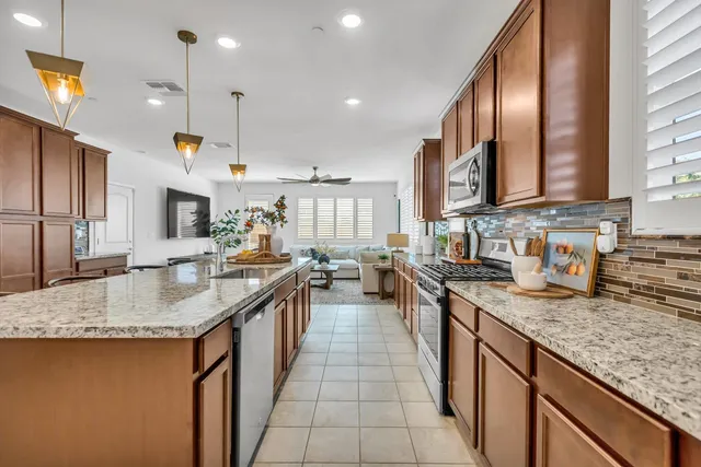a front view of a house with wooden floor and a chandelier