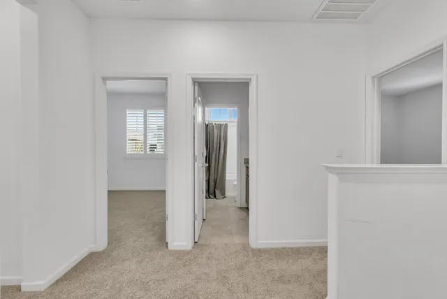 a view of a hallway with wooden shelves
